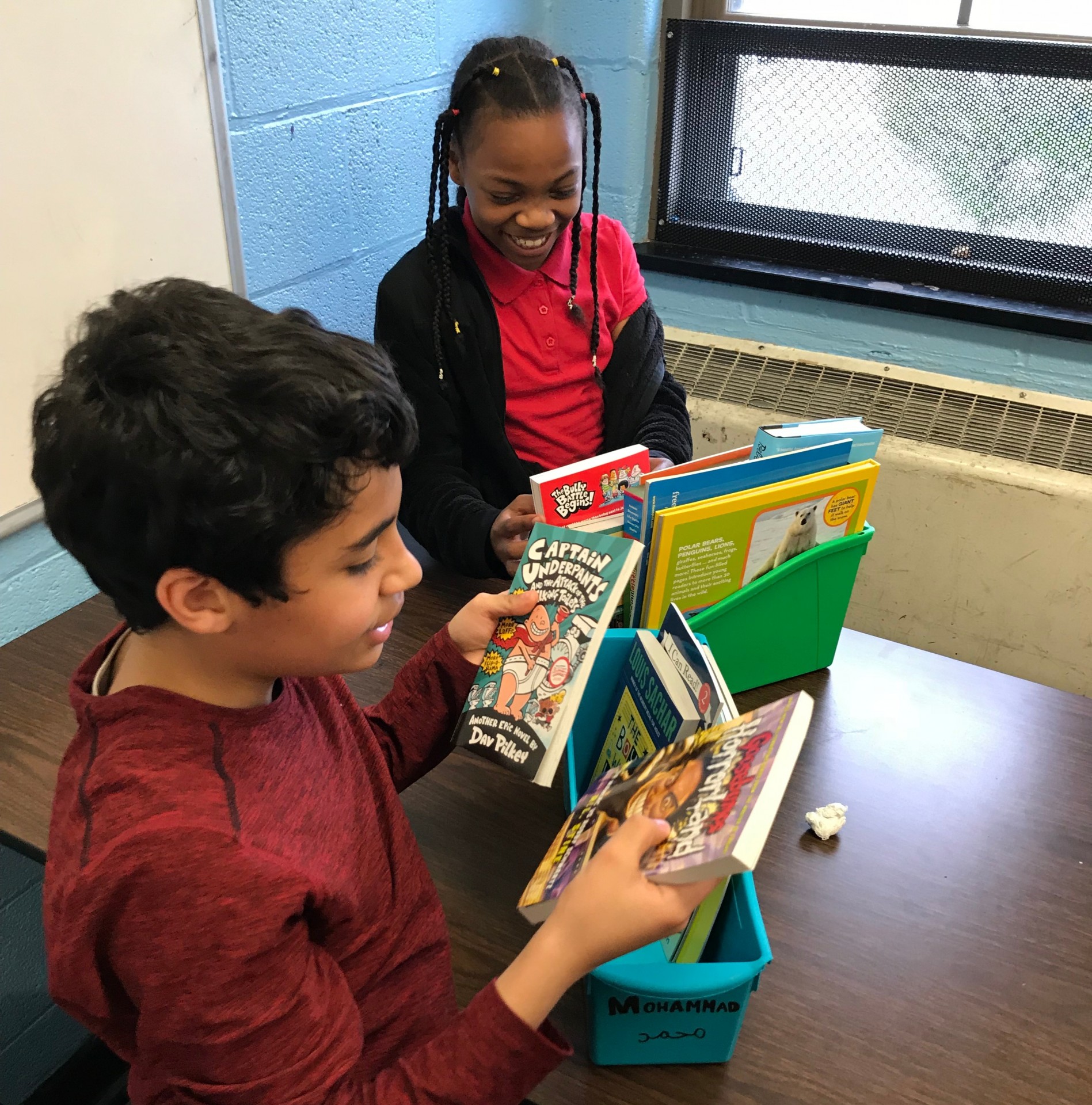 Some of the refugees exploring their mini-libraries.