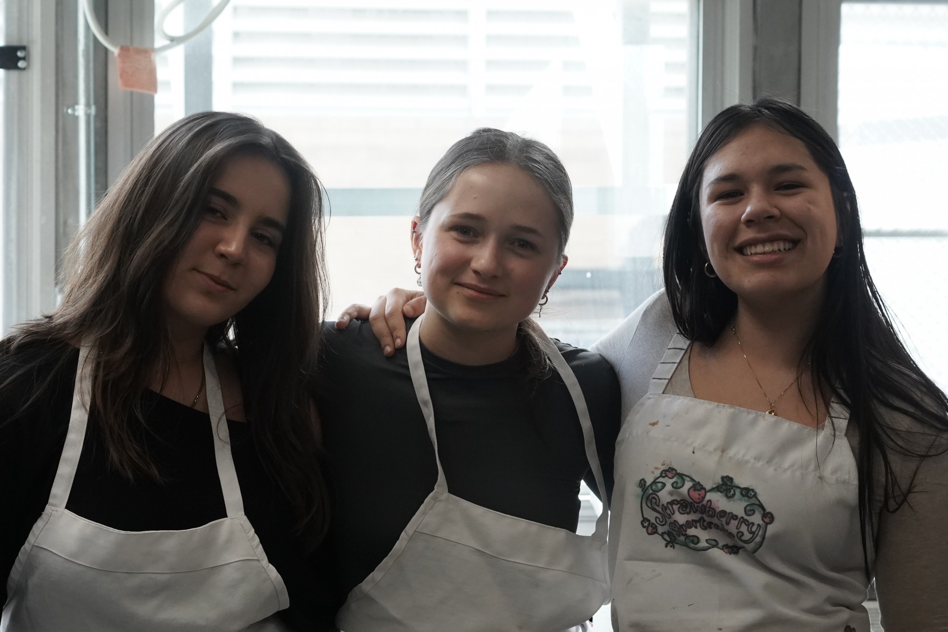Me (Carla Luna-Flores) with German exchange students in the Ben Franklin culinary studio, getting ready to plate food.